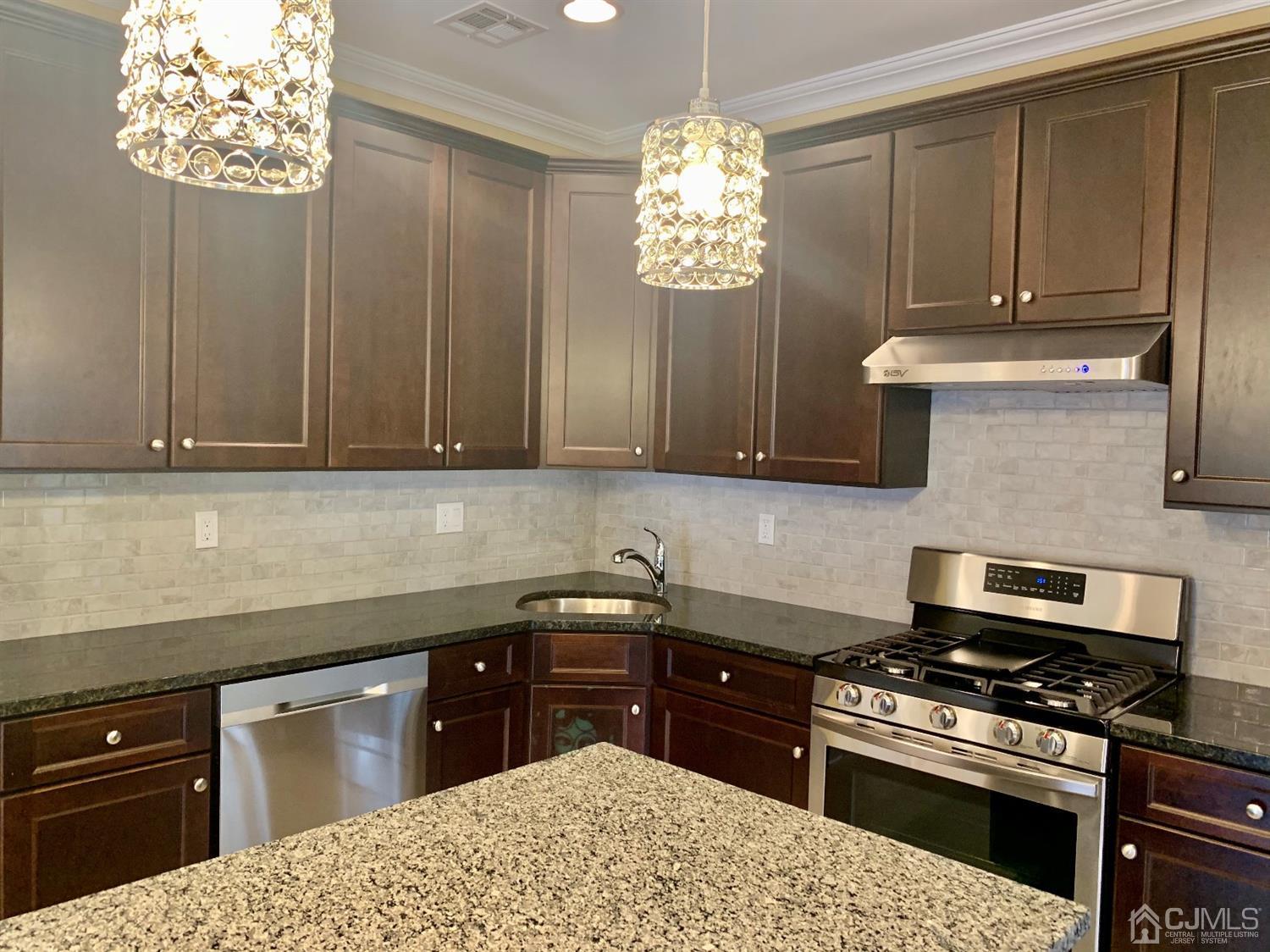 144 Harding Avenue, Unit 2 Edison, NJ 08820 - Photo 8 of 12 a kitchen with stainless steel appliances a stove a sink dishwasher and a microwave oven