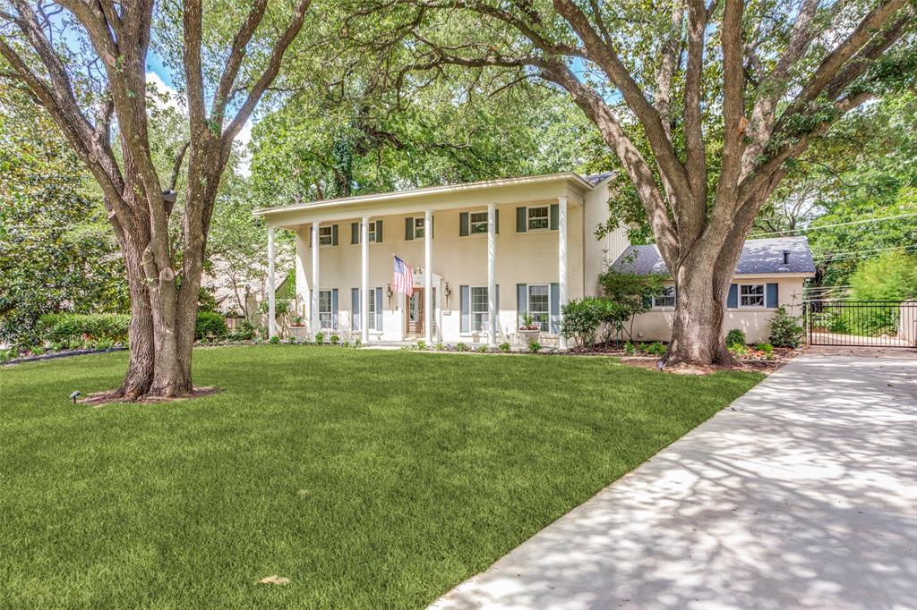 4316 Springbranch Drive Benbrook, TX 76116 - Photo 2 of 39 Cream-colored two-story residence featuring a full-width covered porch with white columns, blue window shutters, and a concrete driveway