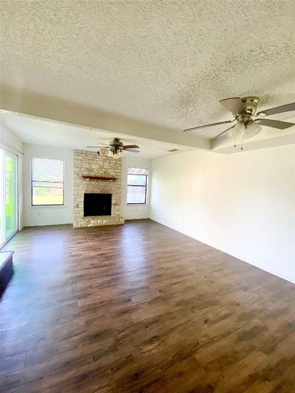 7808 Topawa Cove, Unit B Austin, TX 78729 - Photo 3 of 10 a view of empty room with wooden floor and fireplace