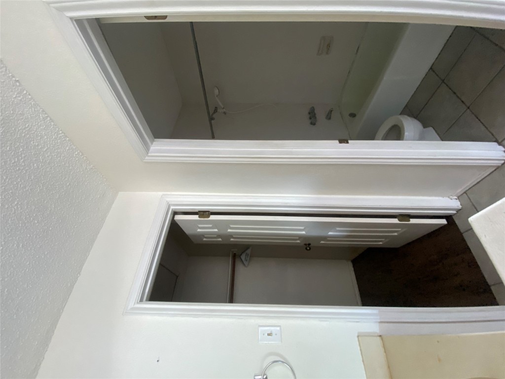 7808 Topawa Cove, Unit B Austin, TX 78729 - Photo 7 of 10 a bathroom with a granite countertop bathtub shower and toilet