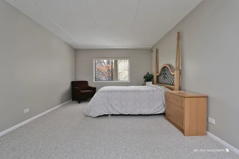 a bedroom with a bed and a television