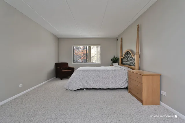 a bedroom with a bed and a television