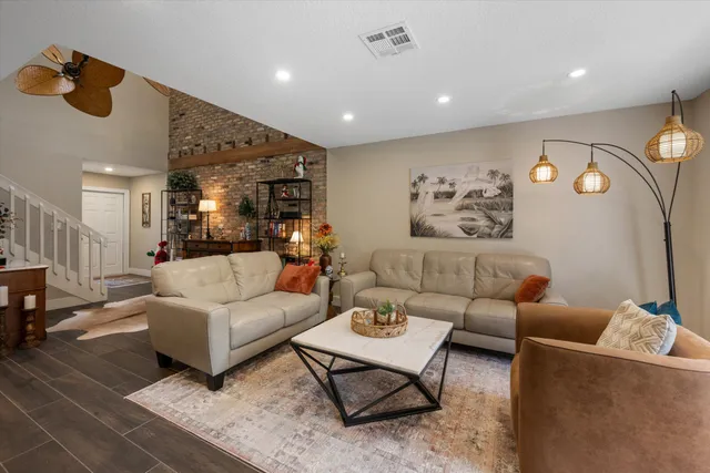 a dining room with furniture a rug and a chandelier