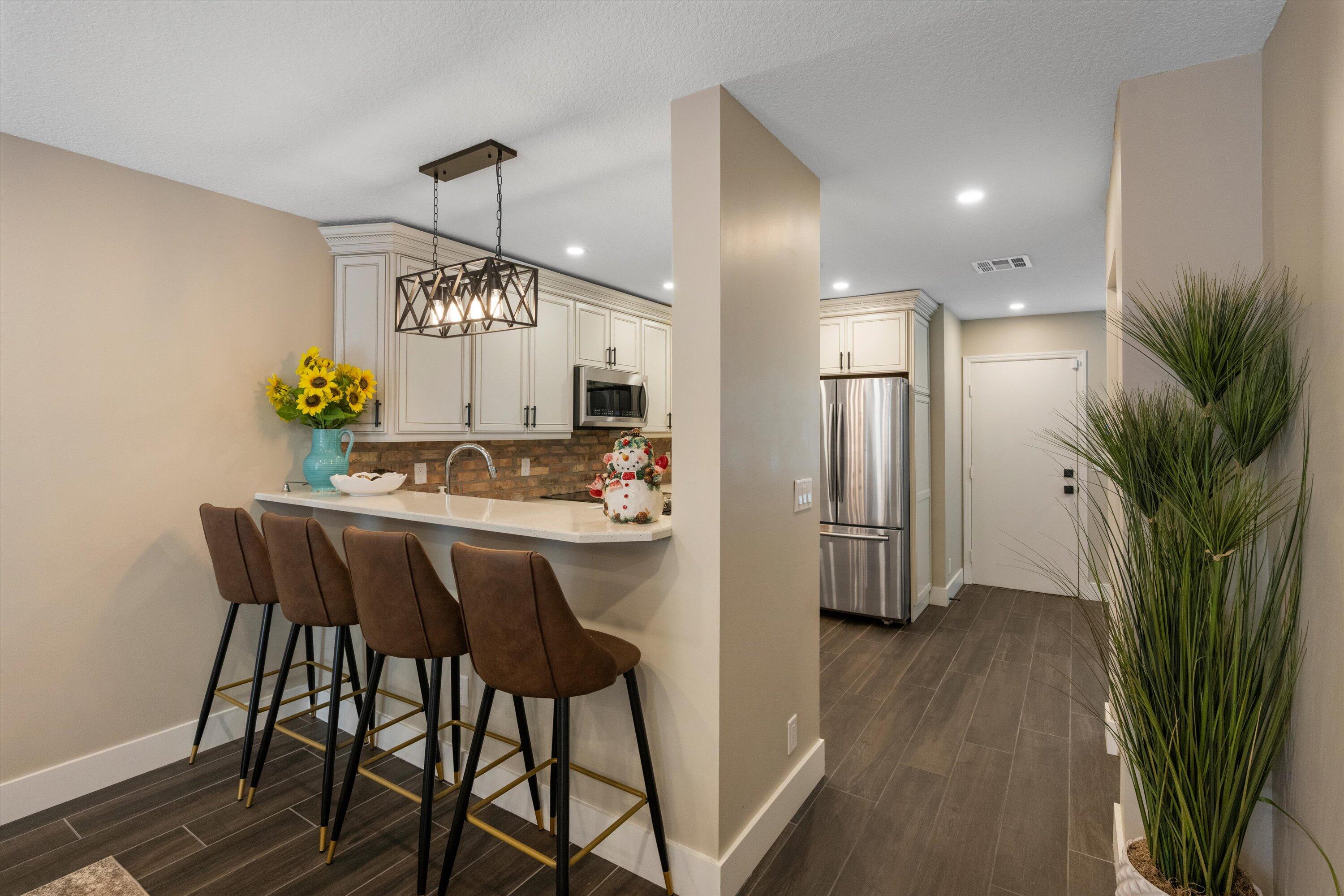 8878 Southeast Riverfront Terrace Jupiter, FL 33469 - Photo 15 of 57 a dining room with furniture potted plants and wooden floor