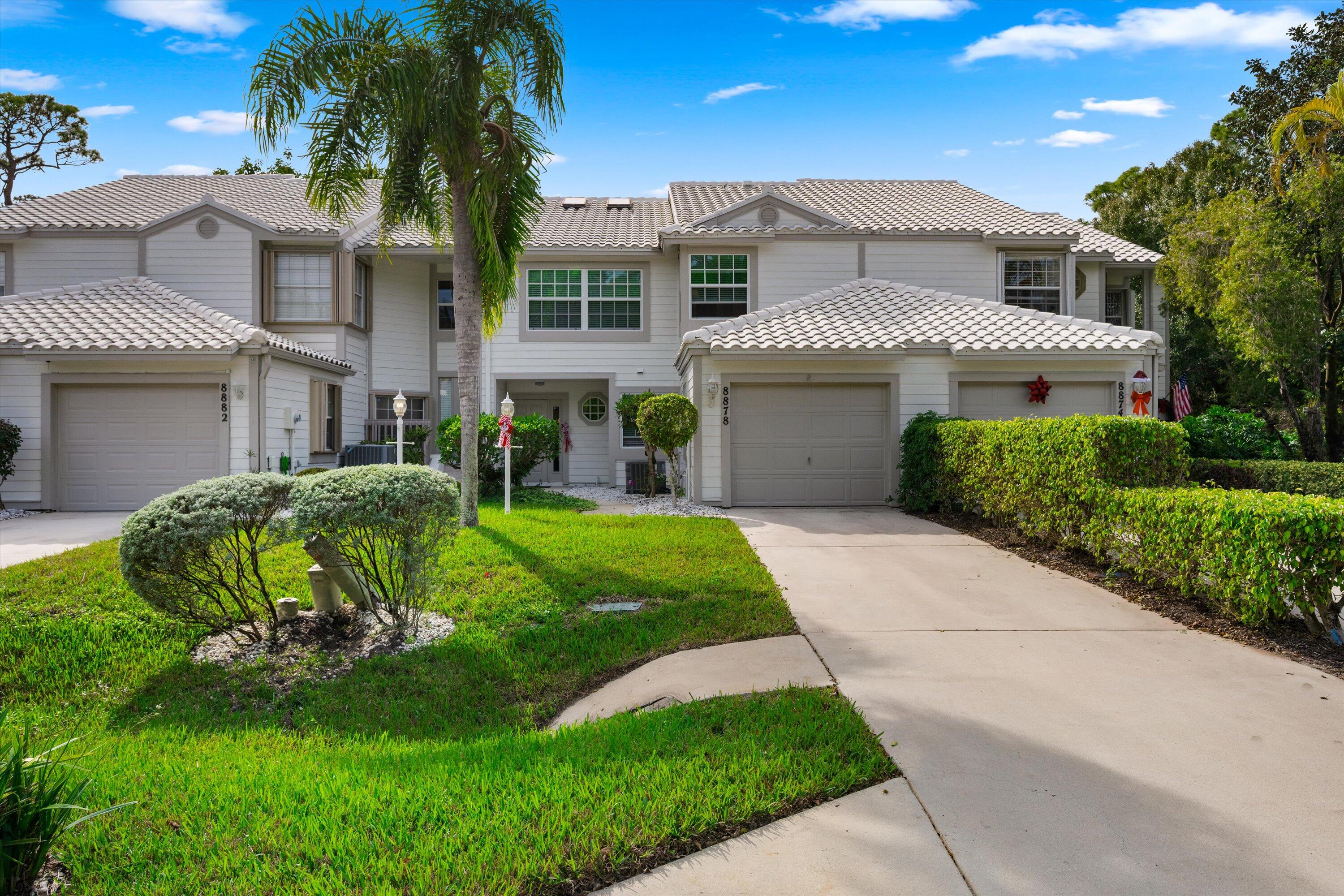 8878 Southeast Riverfront Terrace Jupiter, FL 33469 - Photo 2 of 57 a front view of a house with a garden