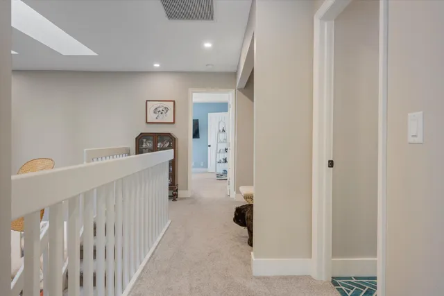 a spacious bedroom with a bed and a flat screen tv