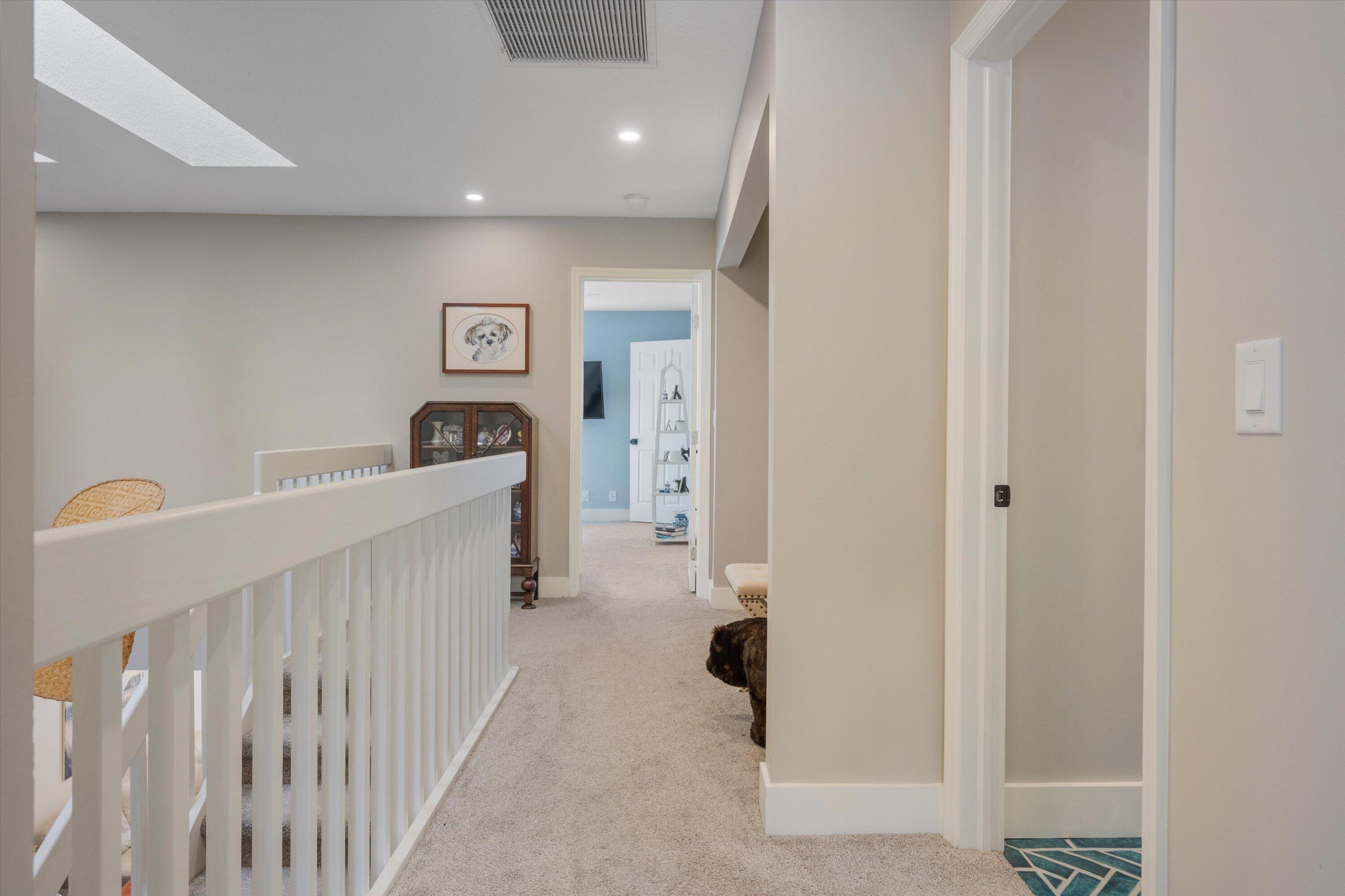 8878 Southeast Riverfront Terrace Jupiter, FL 33469 - Photo 22 of 57 a view of a hallway with a couch and stairs