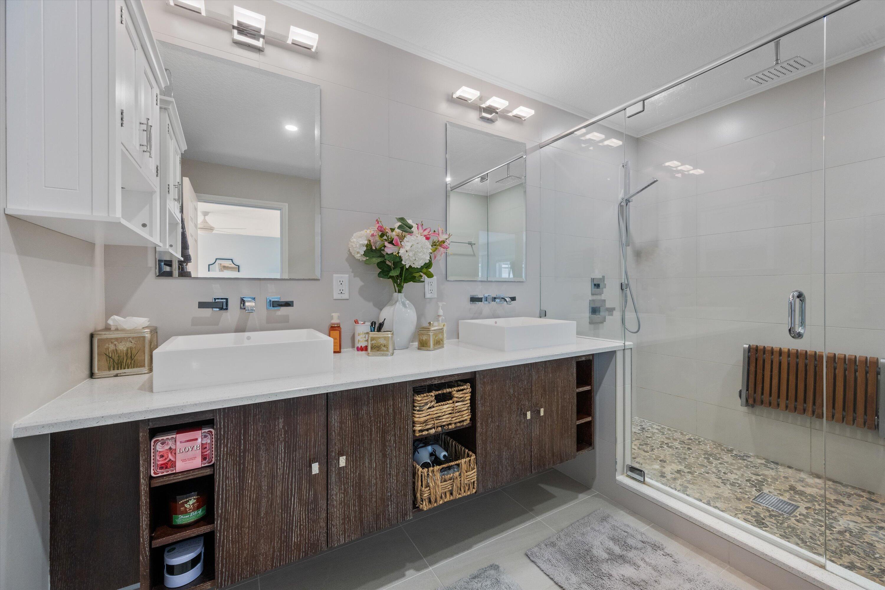 8878 Southeast Riverfront Terrace Jupiter, FL 33469 - Photo 27 of 57 a bathroom with a sink double vanity and a mirror