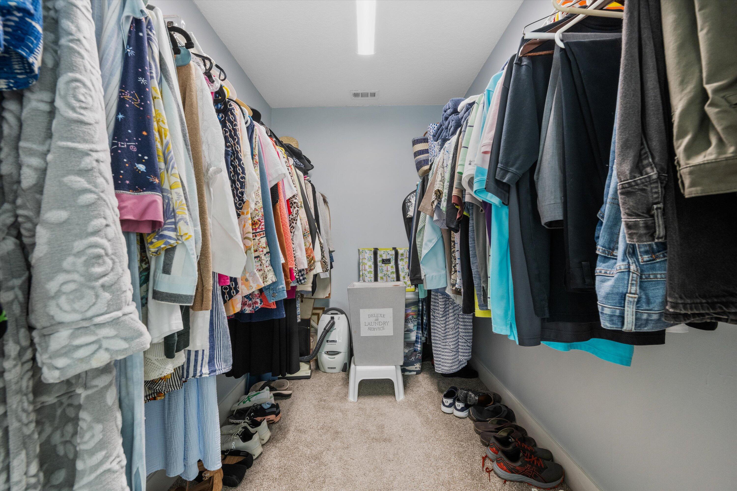 8878 Southeast Riverfront Terrace Jupiter, FL 33469 - Photo 29 of 57 a view of walk in closet with clothes and shoes