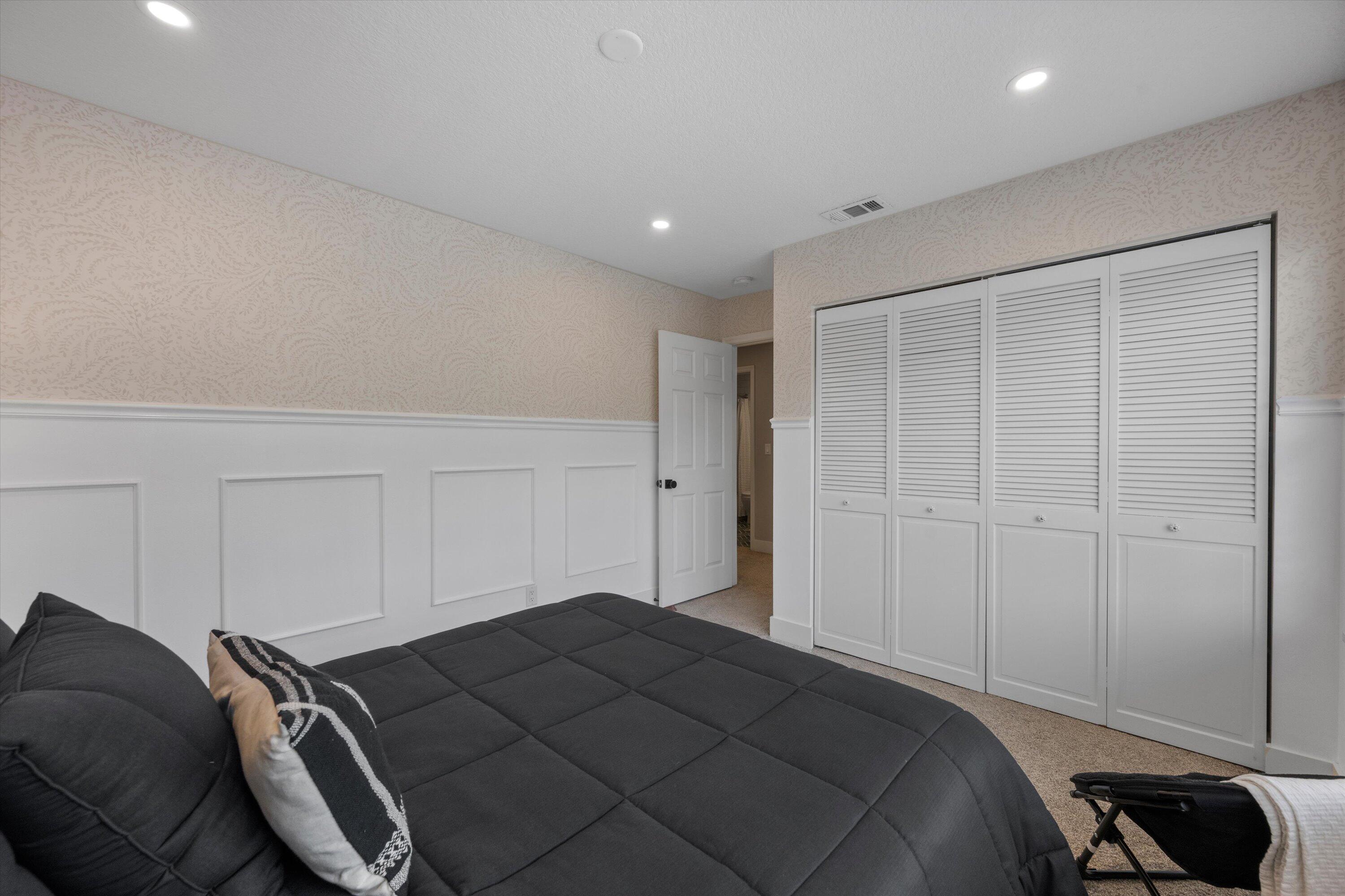 8878 Southeast Riverfront Terrace Jupiter, FL 33469 - Photo 34 of 57 a bedroom with a bed and a walk in closet