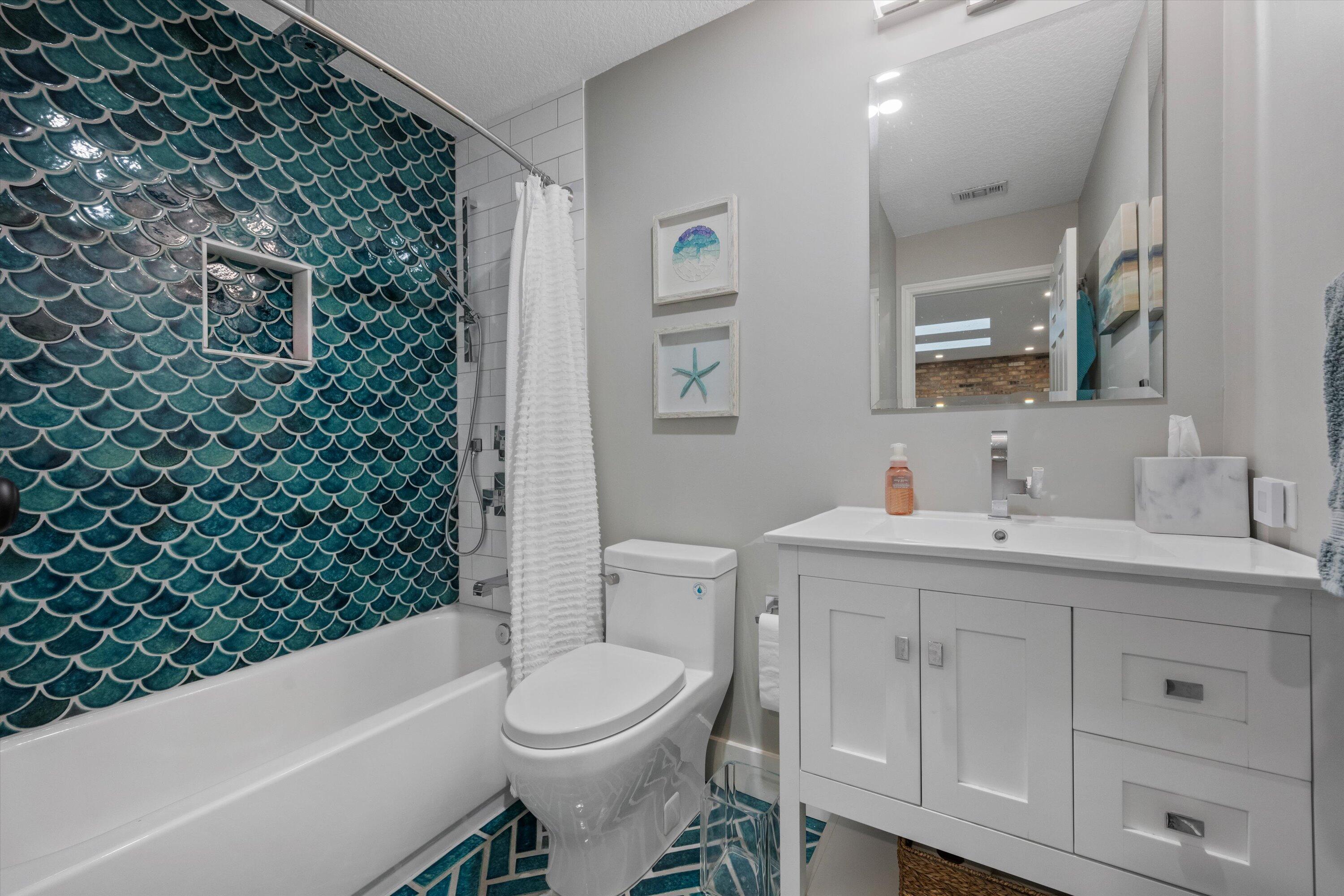8878 Southeast Riverfront Terrace Jupiter, FL 33469 - Photo 35 of 57 a bathroom with a sink a toilet and shower