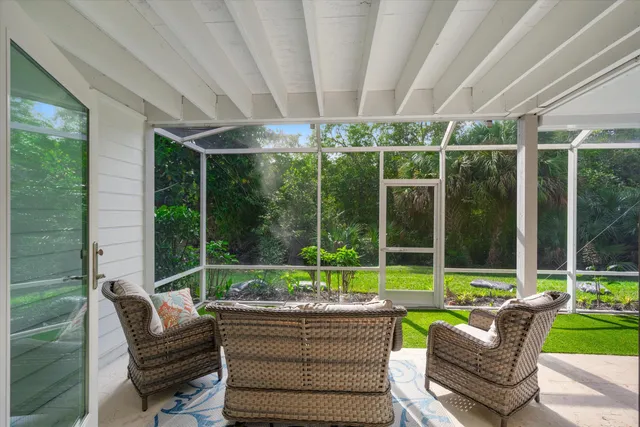 a view of a patio with a table chairs and a backyard