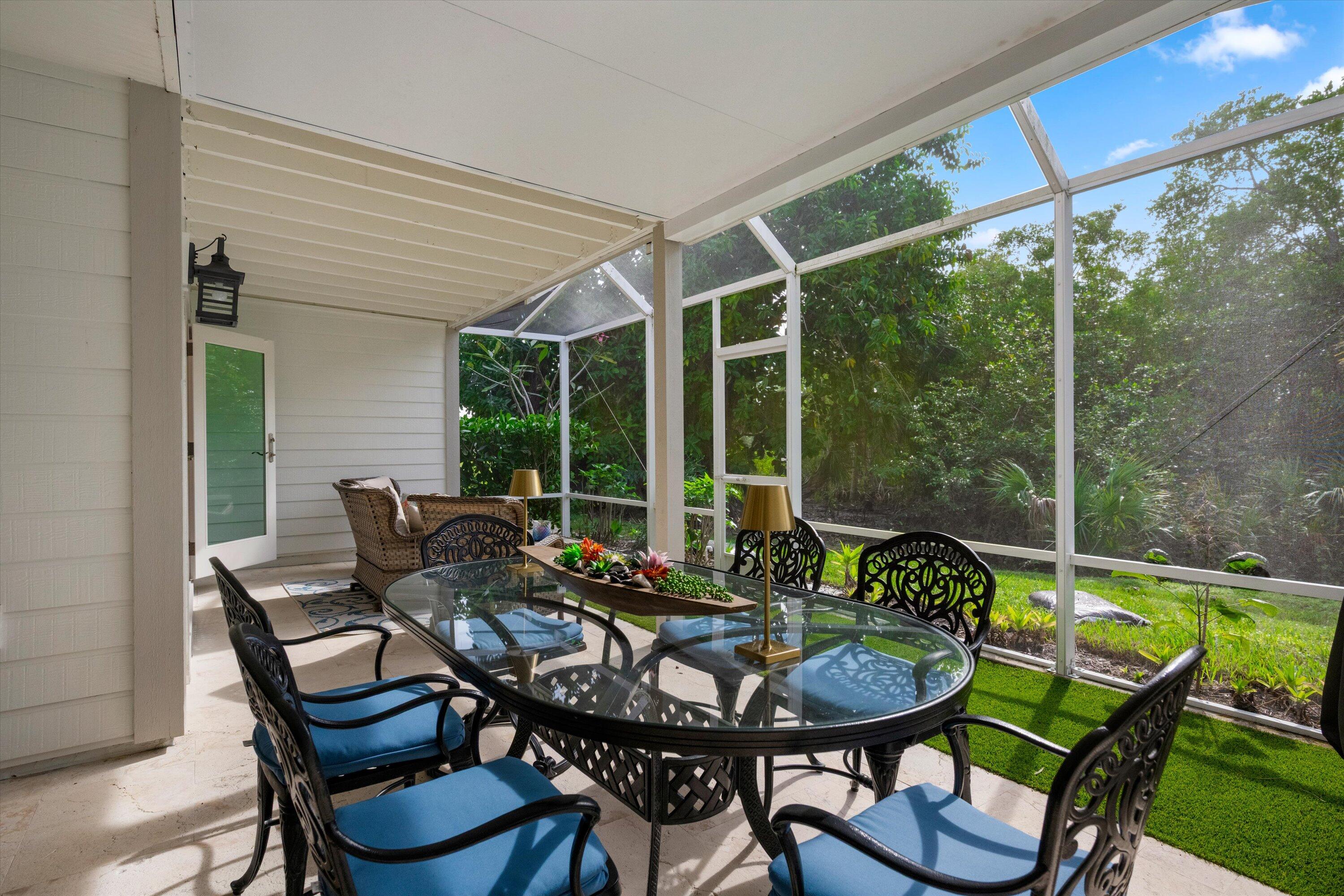 8878 Southeast Riverfront Terrace Jupiter, FL 33469 - Photo 38 of 57 a view of a patio with a dining table and chairs