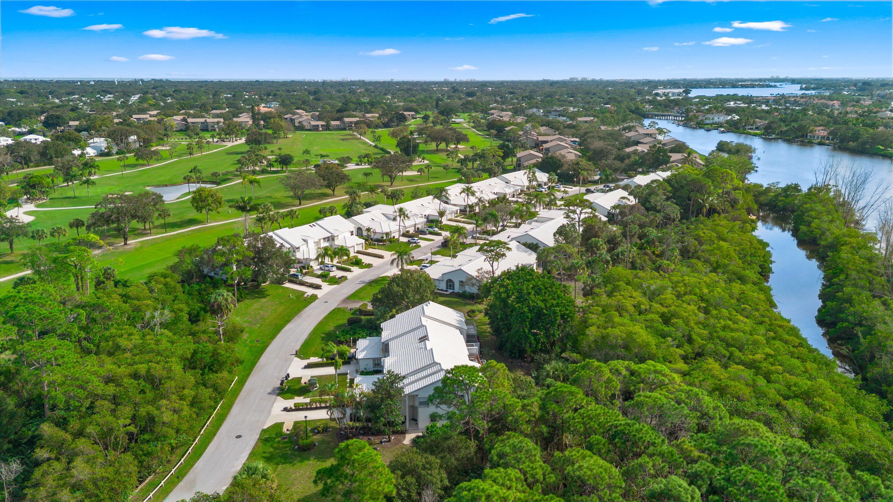 8878 Southeast Riverfront Terrace Jupiter, FL 33469 - Photo 46 of 57 an aerial view of residential houses with outdoor space and trees