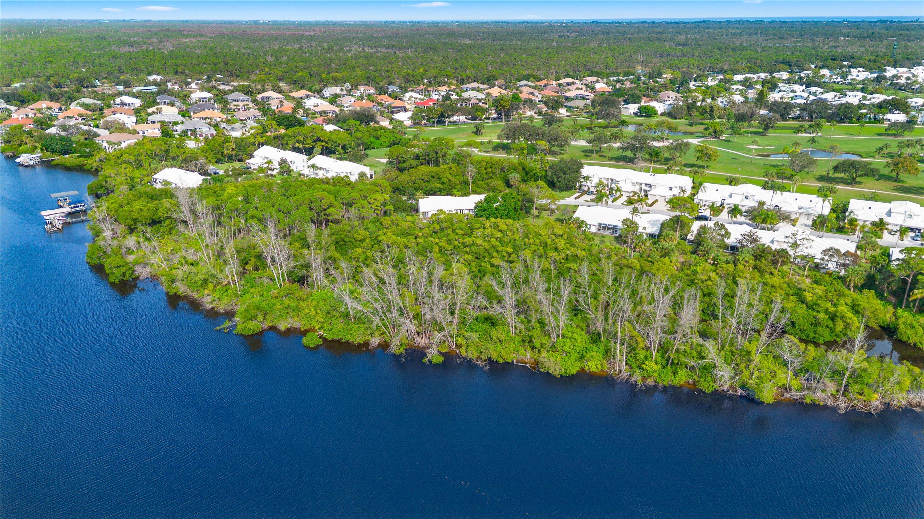 8878 Southeast Riverfront Terrace Jupiter, FL 33469 - Photo 49 of 57 a view of a lake with a yard