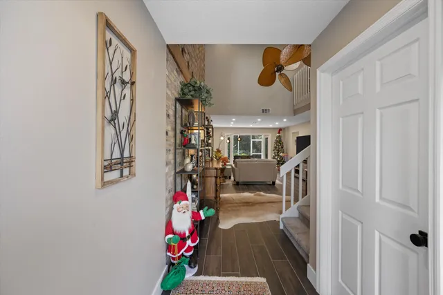a view of entryway and hall with wooden floor