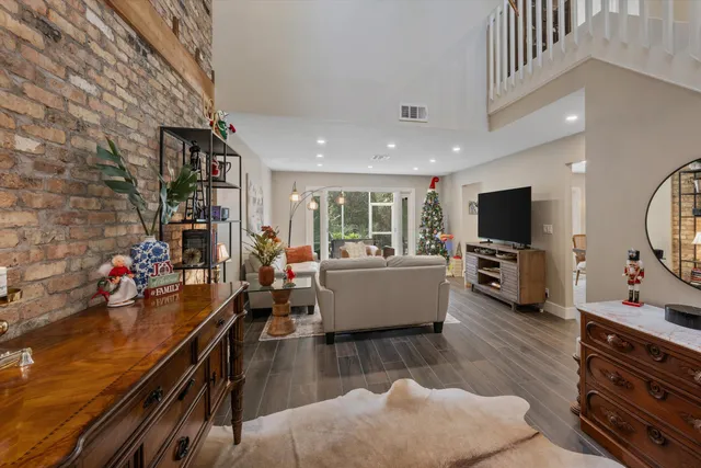 a room with lots of books and a large tree