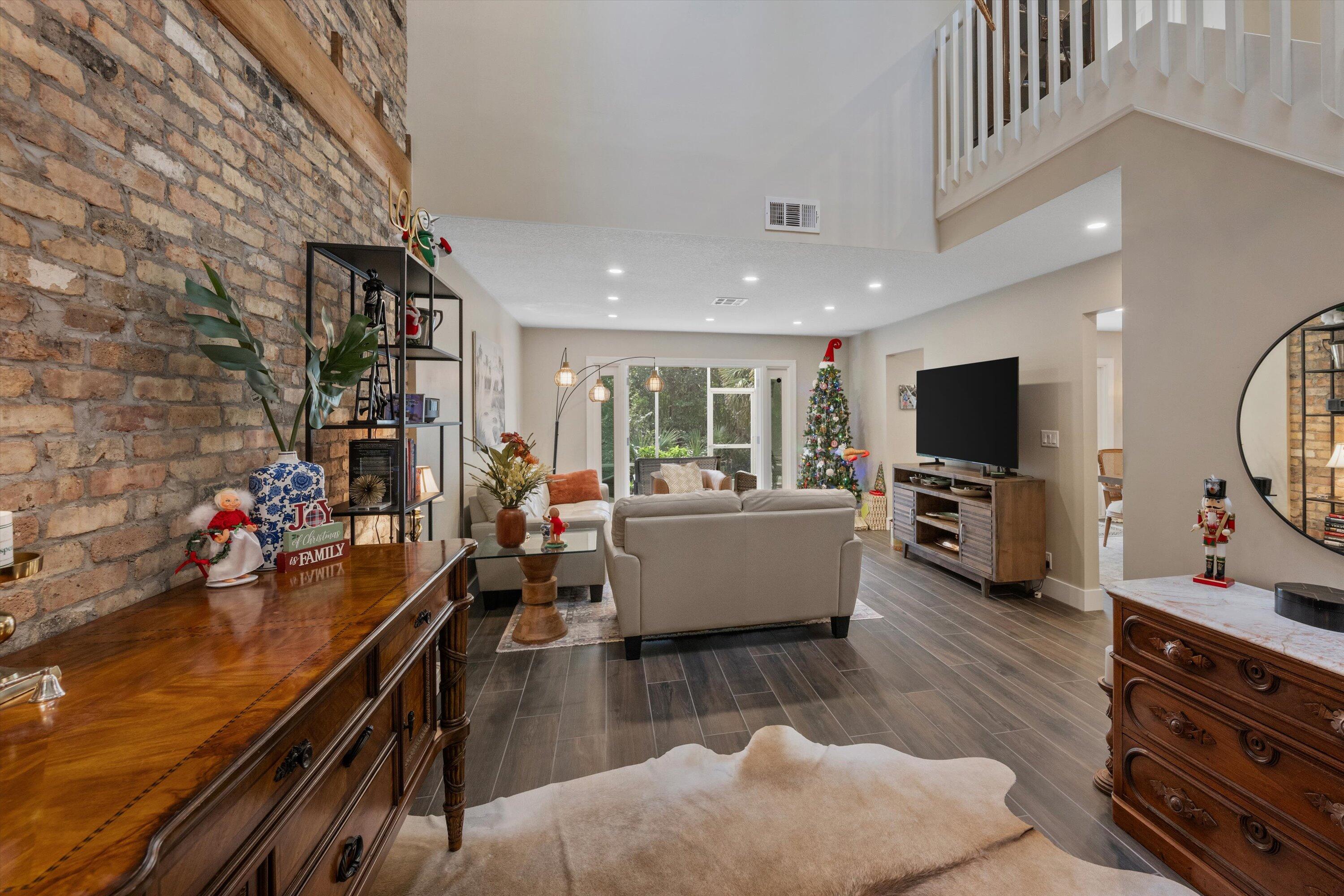 8878 Southeast Riverfront Terrace Jupiter, FL 33469 - Photo 6 of 57 a living room with furniture and a flat screen tv