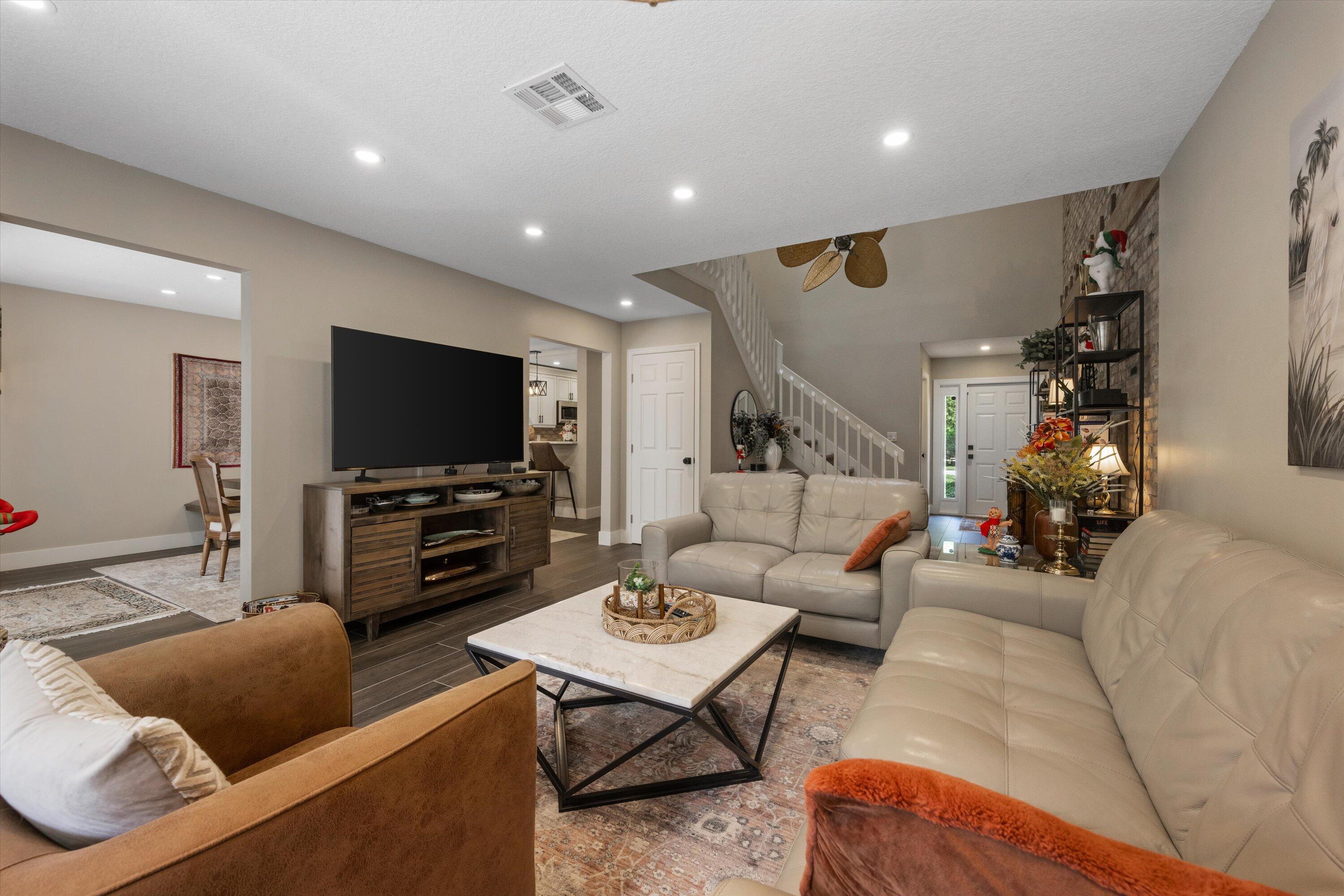 8878 Southeast Riverfront Terrace Jupiter, FL 33469 - Photo 10 of 57 a living room with furniture and a flat screen tv
