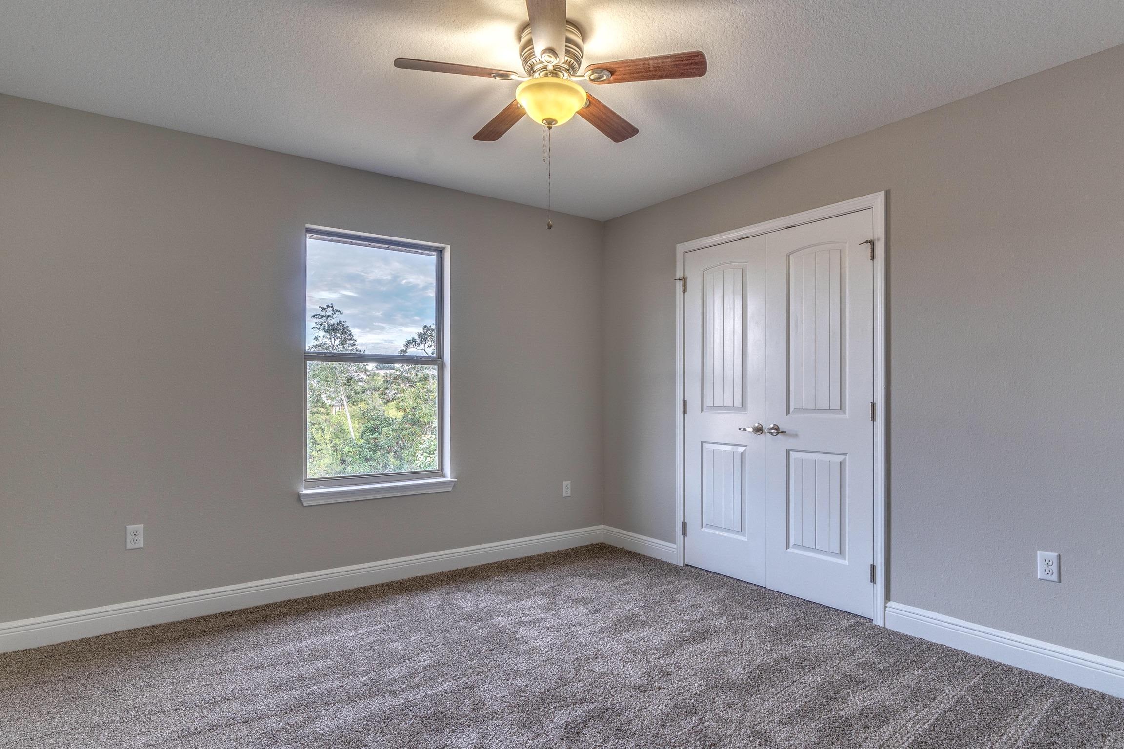 129 Bronze Circle Crestview, FL 32539 - Photo 23 of 31 an empty room with closet and windows