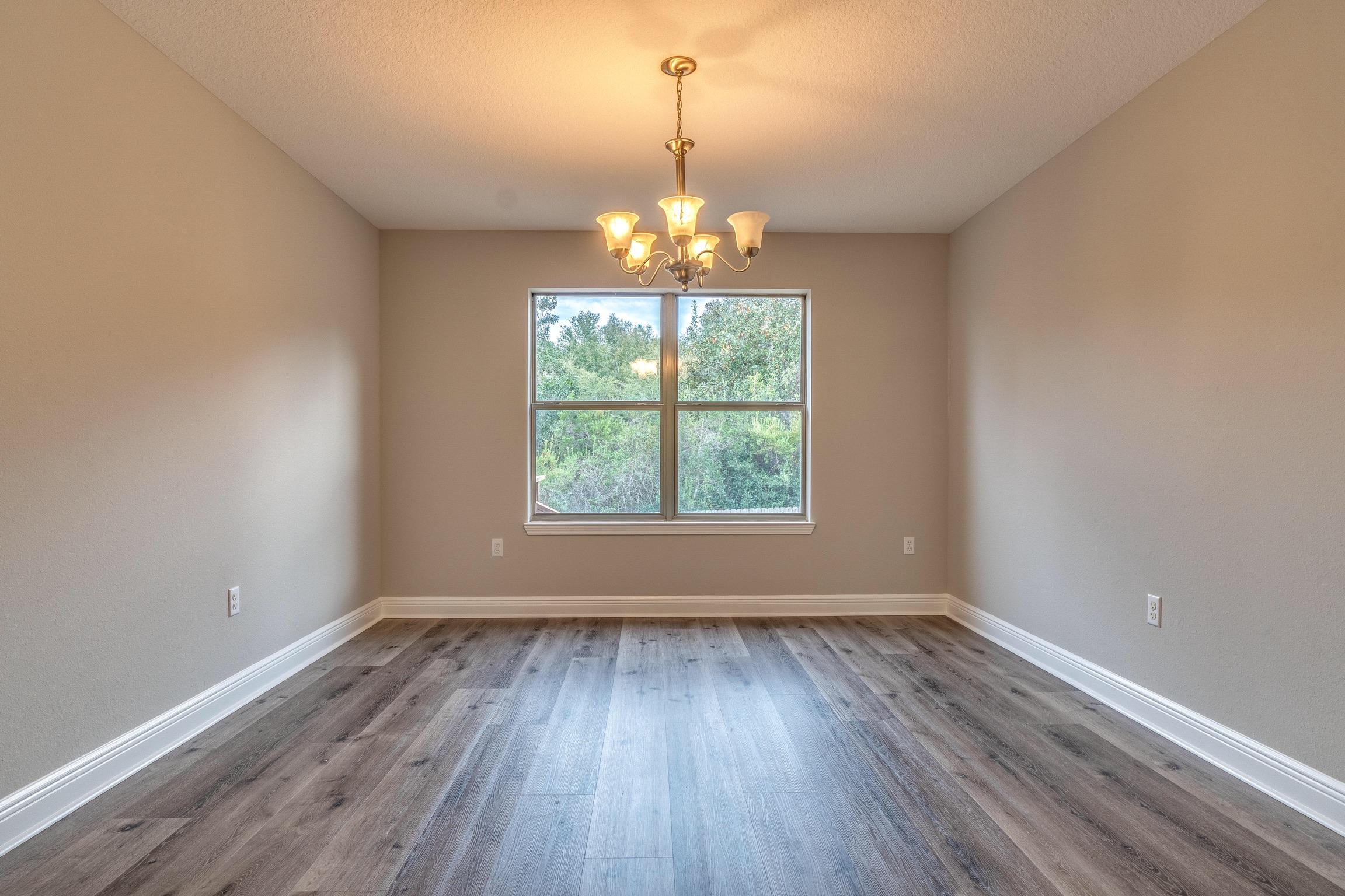 129 Bronze Circle Crestview, FL 32539 - Photo 25 of 31 an empty room with wooden floor and windows