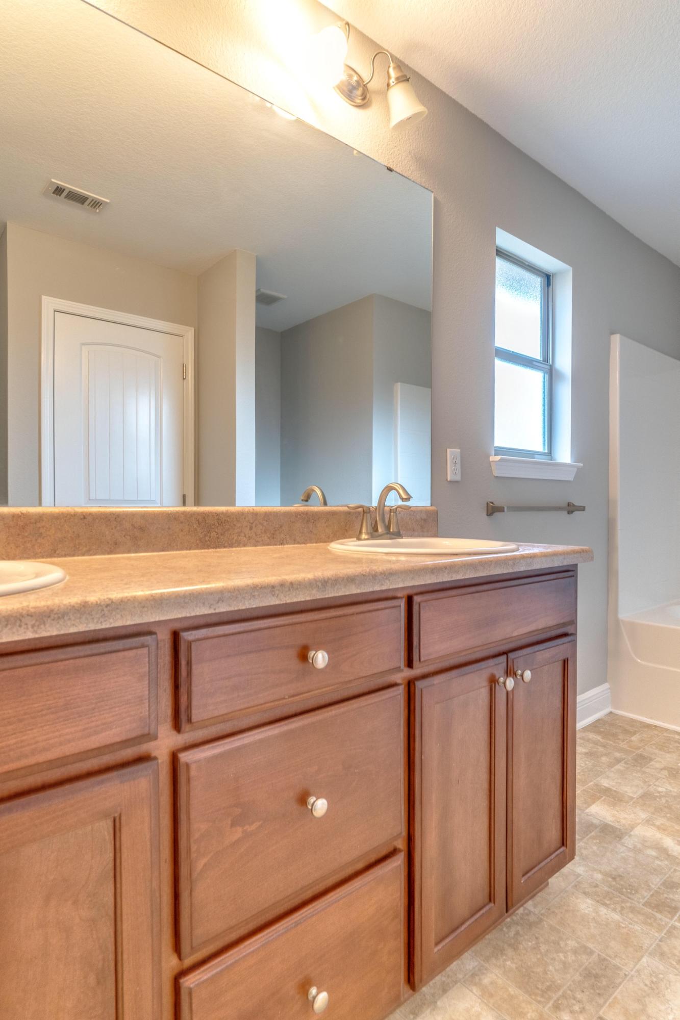 129 Bronze Circle Crestview, FL 32539 - Photo 28 of 31 a bathroom with a sink and a mirror