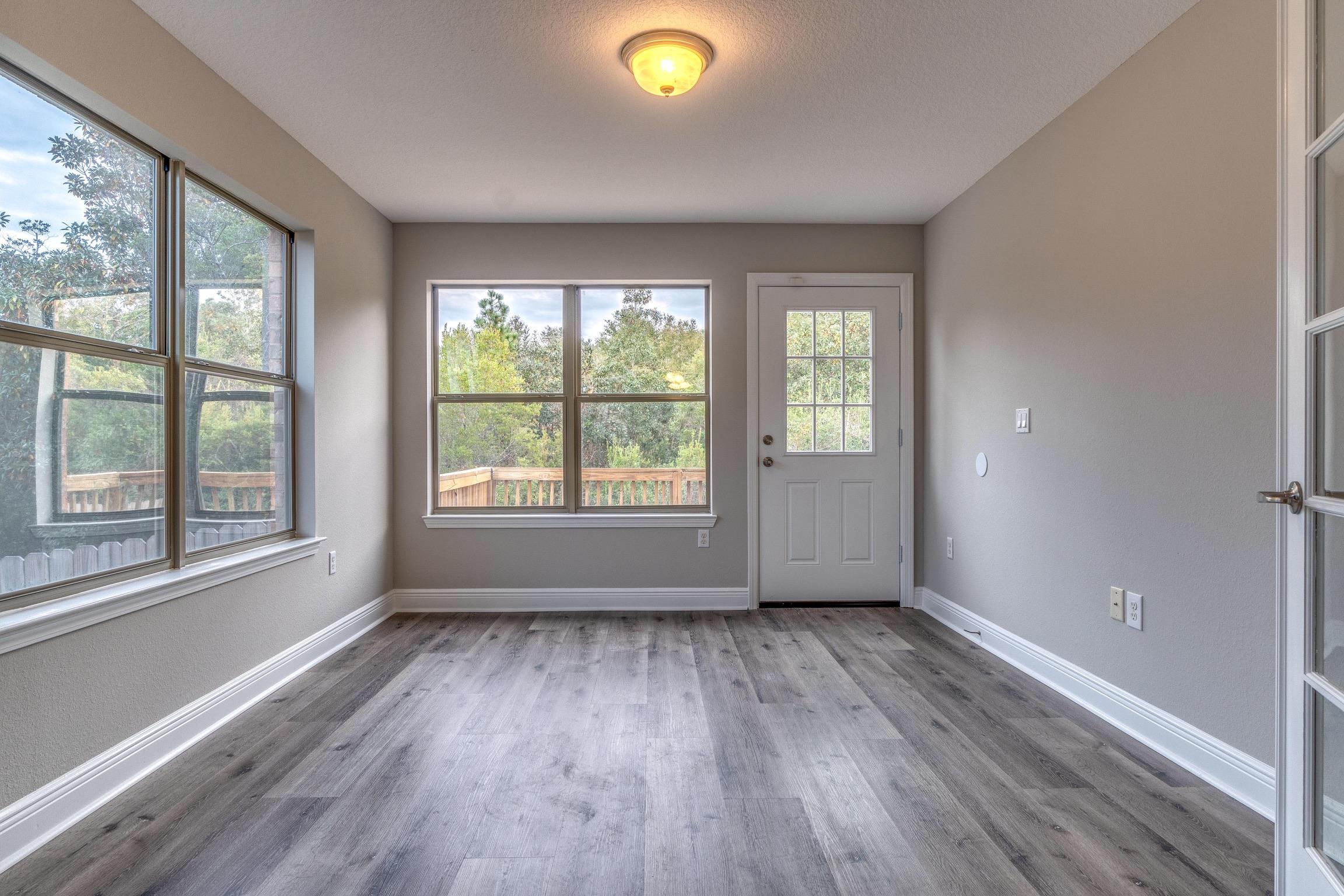 129 Bronze Circle Crestview, FL 32539 - Photo 8 of 31 wooden floor in an empty room with a window