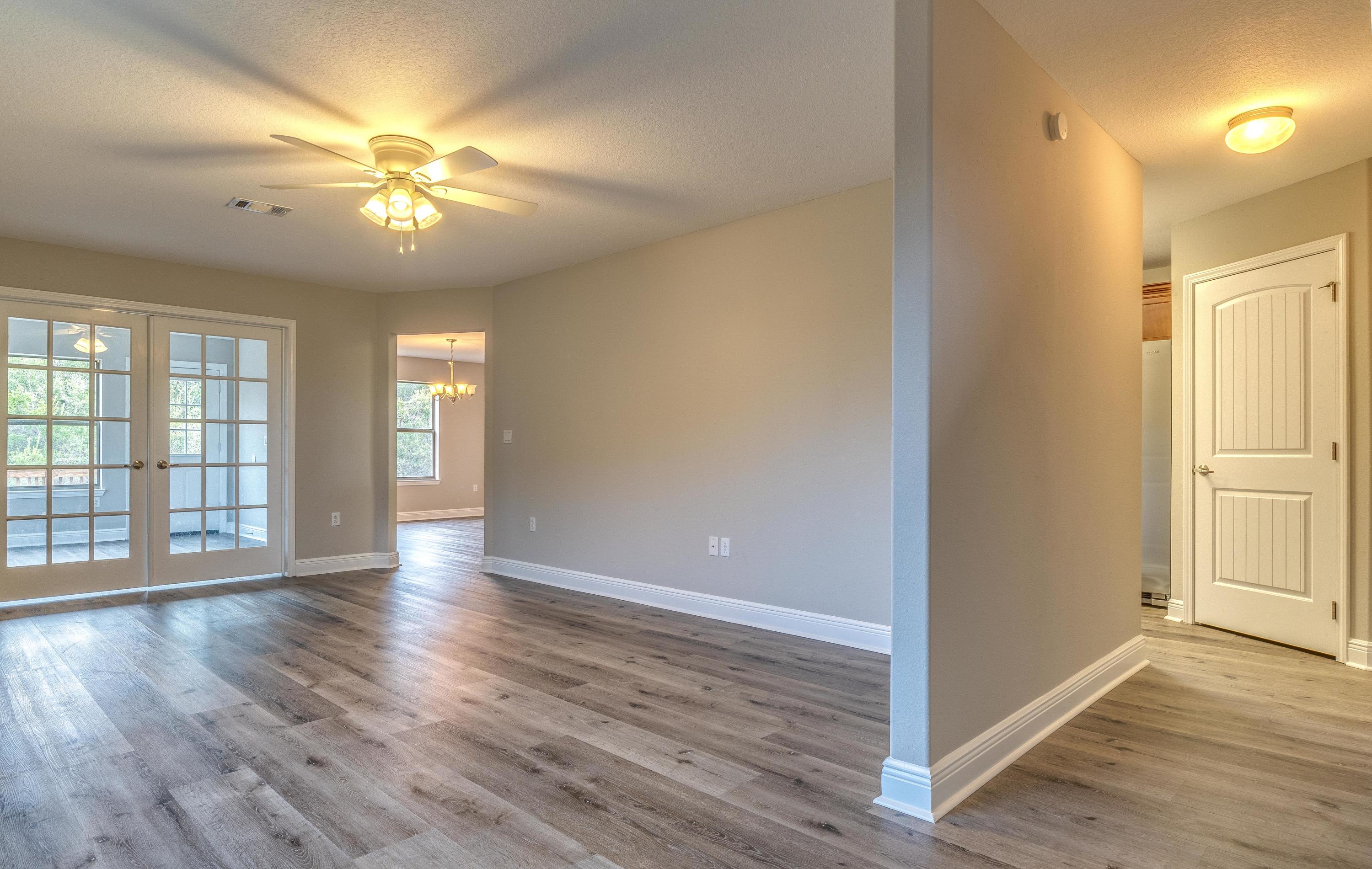 129 Bronze Circle Crestview, FL 32539 - Photo 9 of 31 a view of an empty room with wooden floor and a window