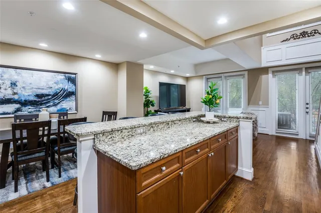 a kitchen with stainless steel appliances granite countertop wooden cabinets and sink