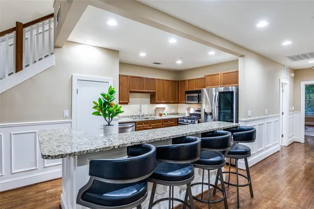 a kitchen with granite countertop stainless steel appliances a sink and counter space