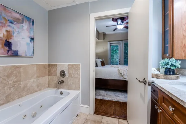 a en suite bathroom with a tub a sink and mirror