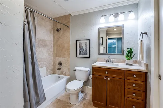 a bathroom with a sink a toilet a mirror a vanity and shower