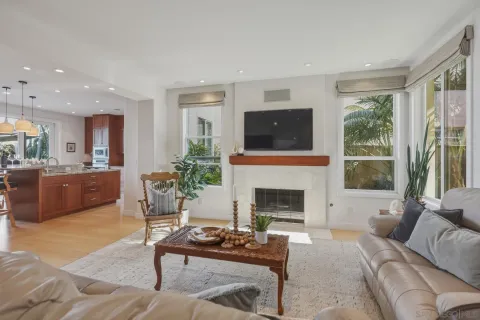 a living room with furniture fireplace and a large window