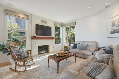 a living room with furniture a flat screen tv and a fireplace