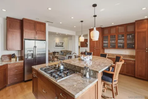 a kitchen with a table chairs stove and wooden floor