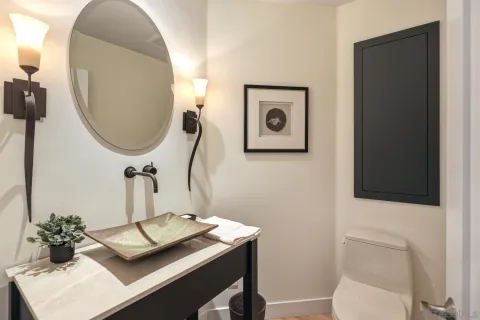 a bathroom with a toilet sink and mirror