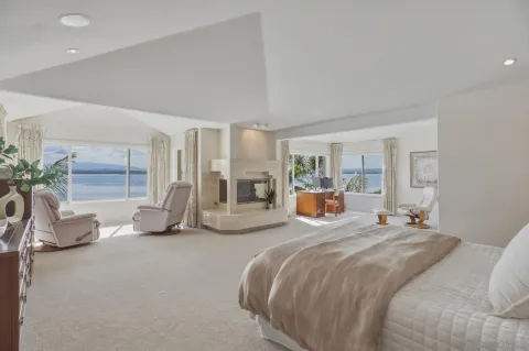a bedroom with bed and a large mirror