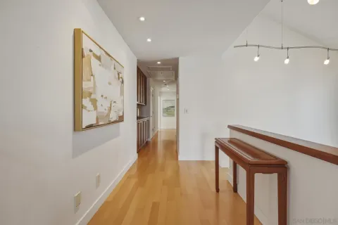 a view of hallway with wooden floor