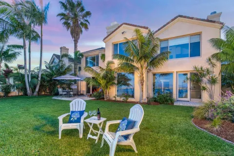 a view of a chair and table in the patio in front of house