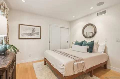 a bedroom with bed and a large mirror