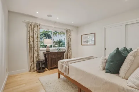 a spacious bedroom with a large bed and a balcony