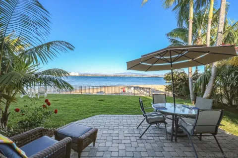 a view of a patio with table and chairs under an umbrella