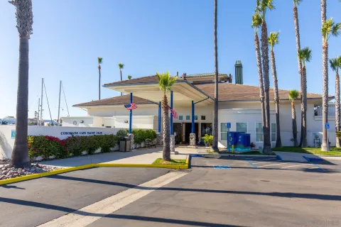 a view of a white building with palm trees