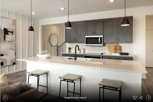 a kitchen with stainless steel appliances a refrigerator sink and microwave