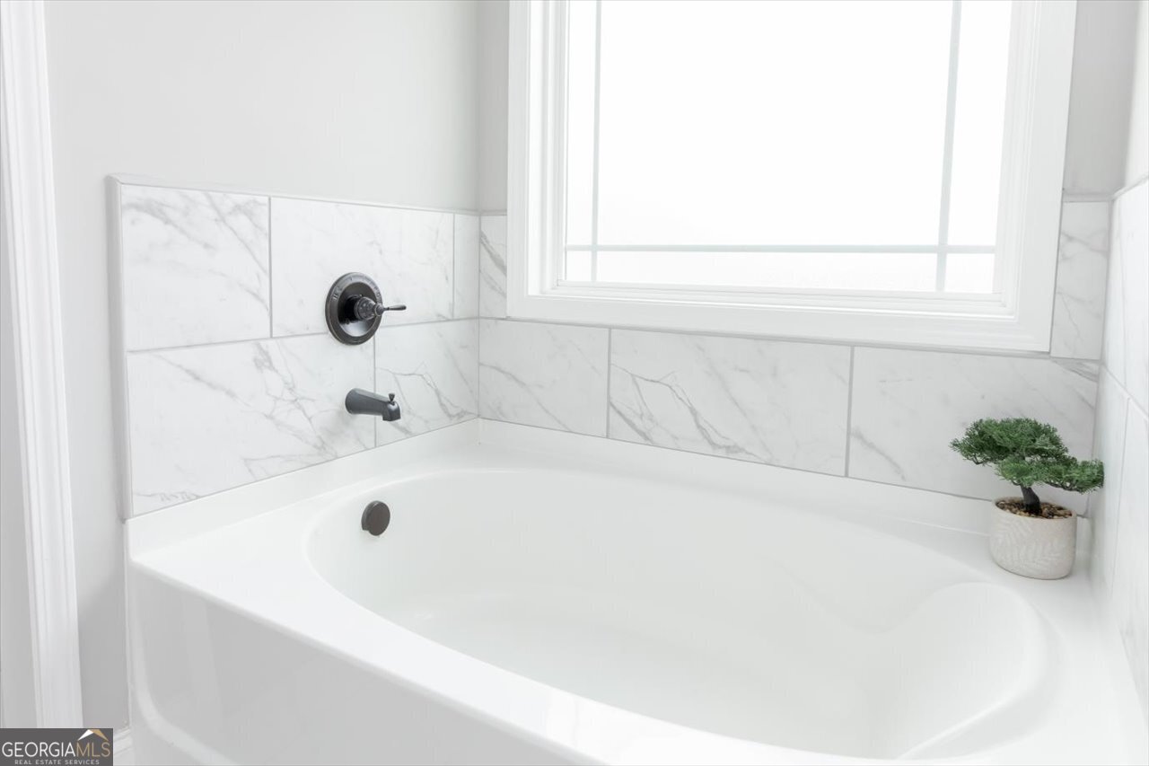 104 Meredith Layne Court Perry, GA 31069 - Photo 29 of 46 a white bath tub sitting in a bathroom