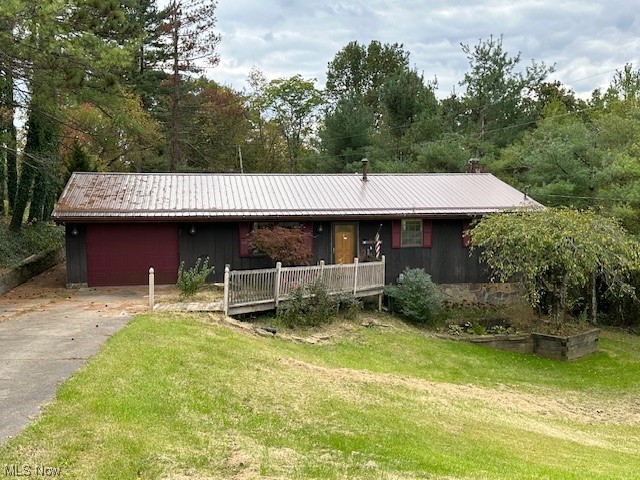 Single story home with a front yard and a garage