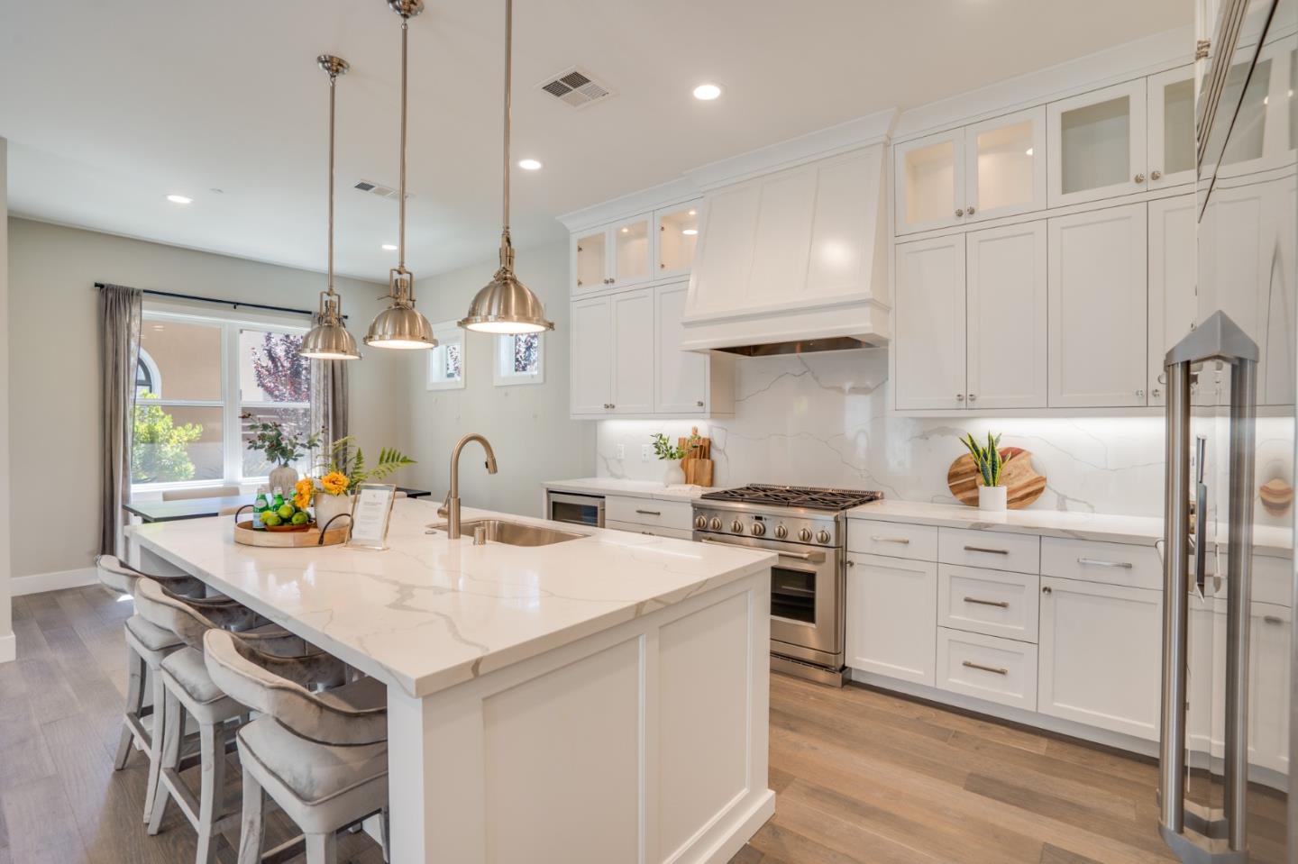 3114 Contreras Drive San Mateo, CA 94403 - Photo 14 of 44 a kitchen that has a lot of cabinets in it and wooden floors