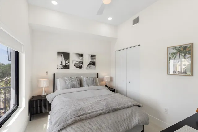 a bedroom with a bed and painting on the wall