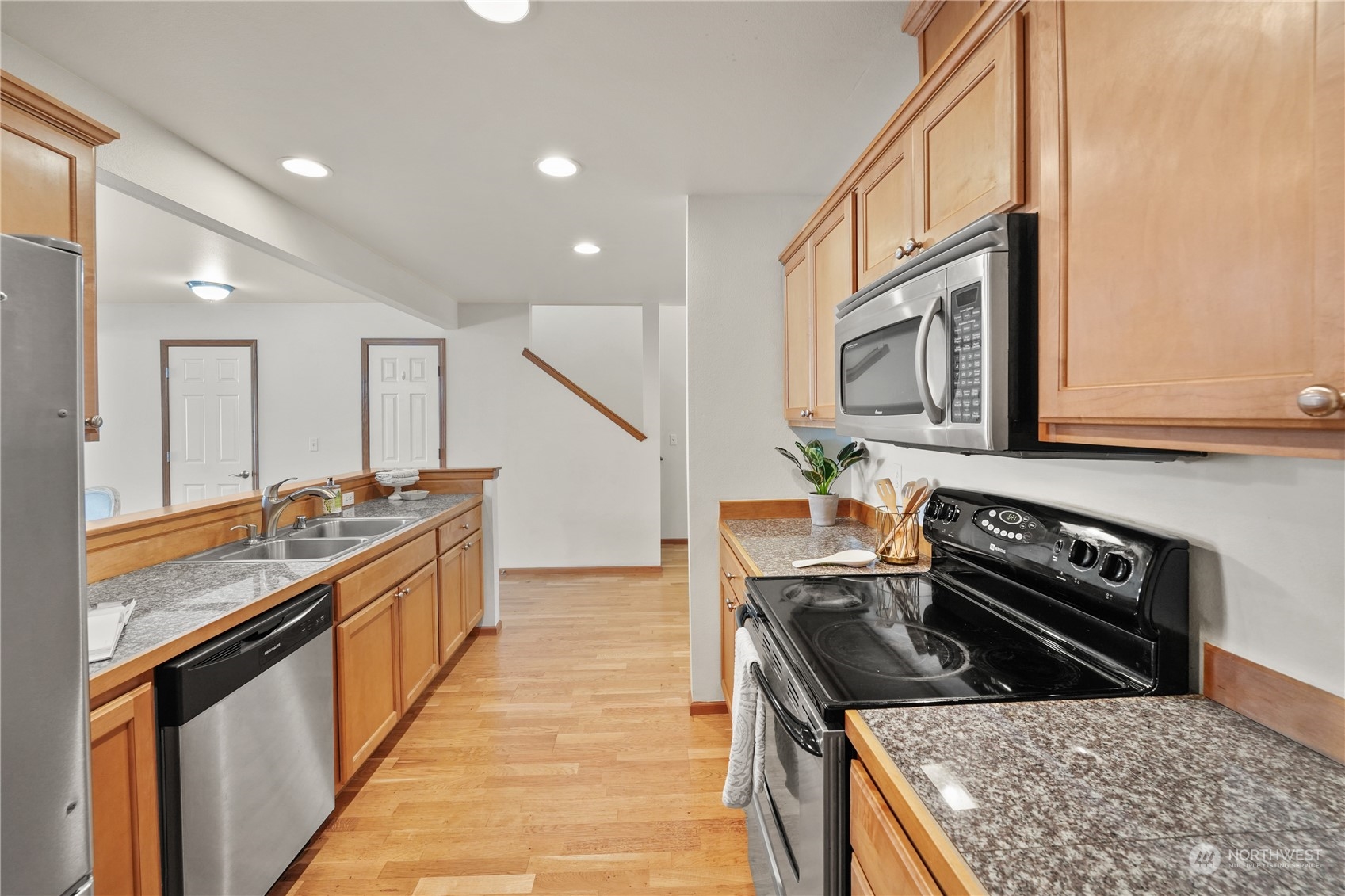 2114 19th Street Anacortes, WA 98221 - Photo 7 of 35 a kitchen with stainless steel appliances granite countertop a stove a sink and a microwave