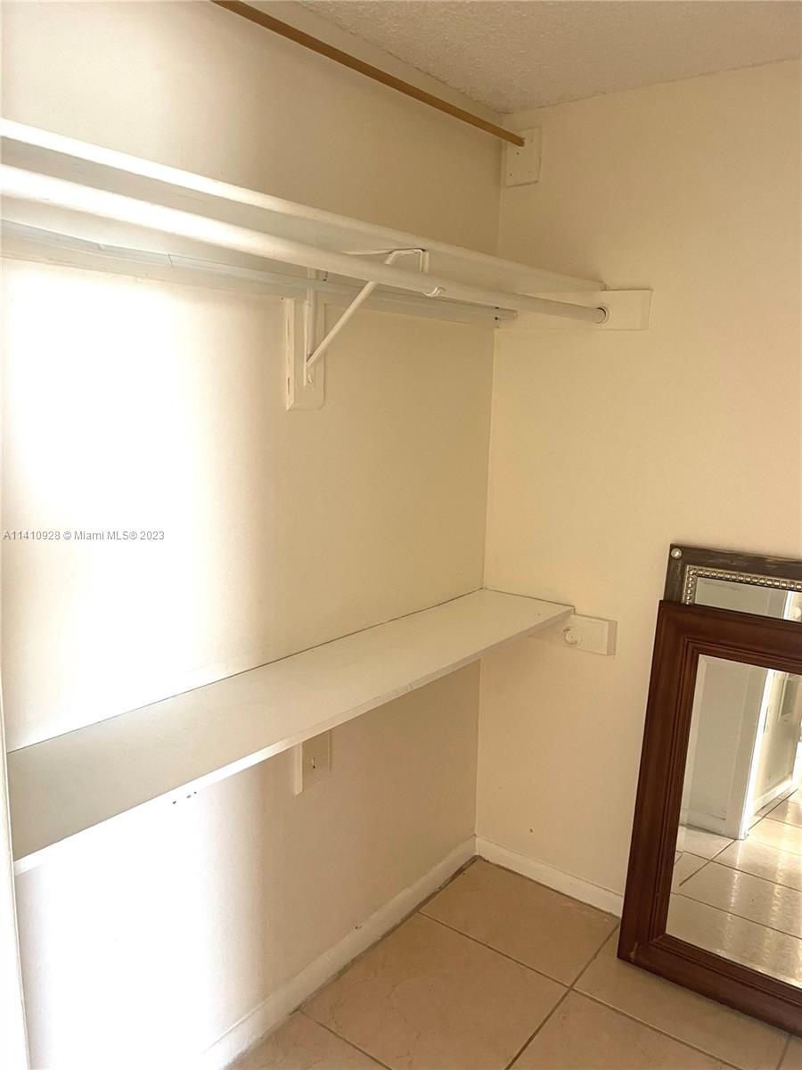 8600 Southwest 133rd Avenue Road, Unit 416 Miami, FL 33183 - Photo 12 of 23 a view of walk in closet with empty racks